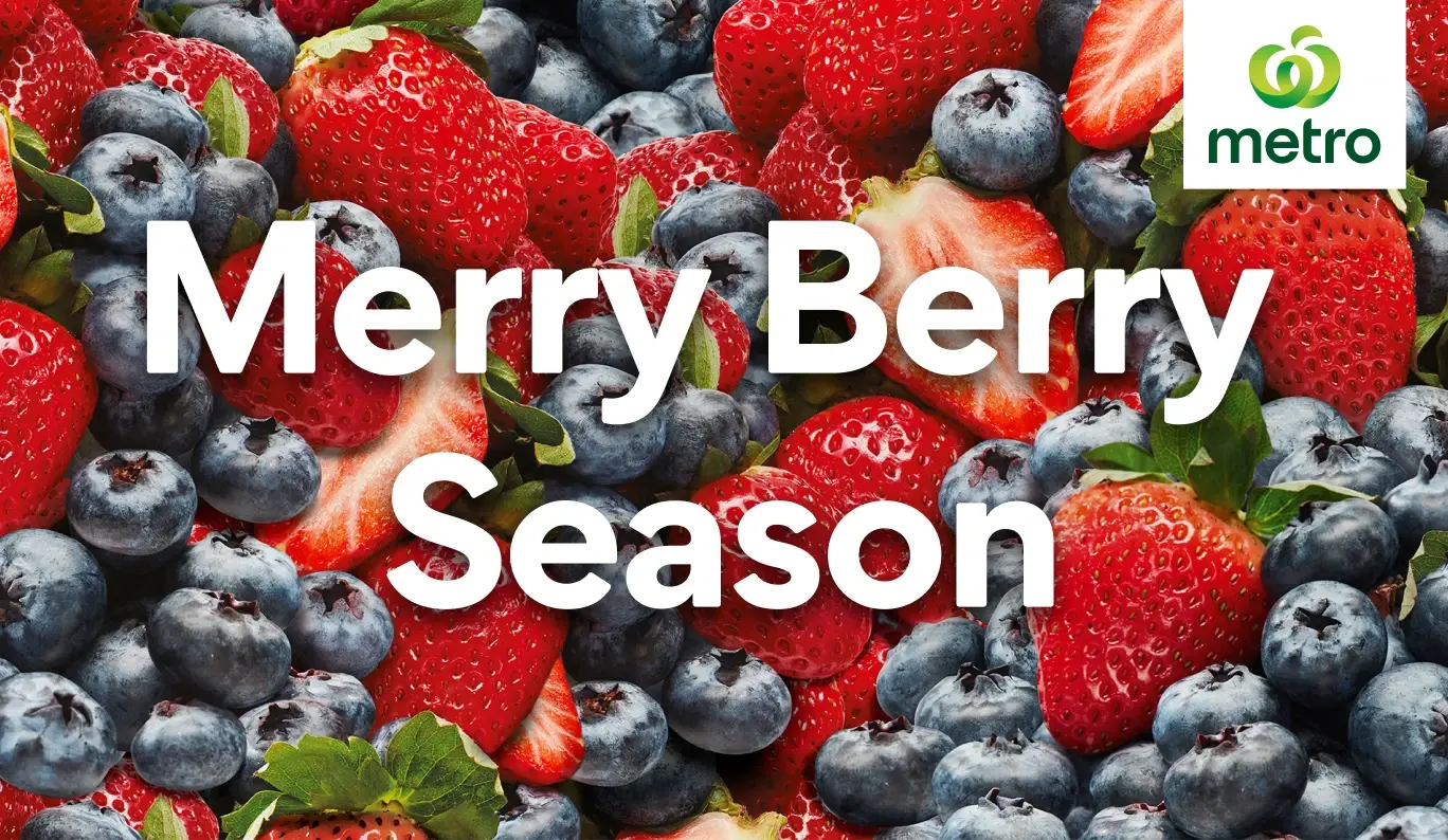Fresh strawberries and blueberries with the text "Merry Berry Season"